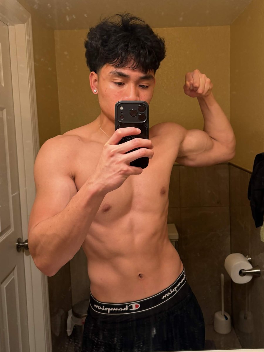 Ethan after, flexing his bicep in a mirror