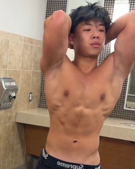 Aiden Tran after one year, posing with arms behind his head showing a lean, muscular build