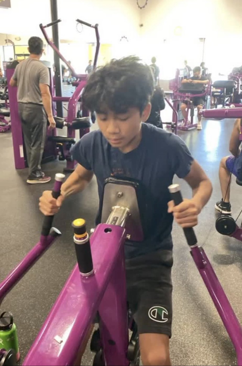 Ethan before, training on a machine at the gym